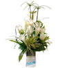 White Lilies With Song Of India In Clear Glass Filled With Blue Pebbles 