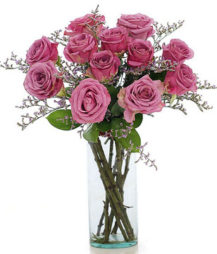 12 Purple roses in a glass vase