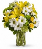 yellow roses, lilies and other bright blooms