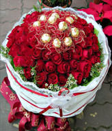 50 red roses and Ferrero Rocher 12 yarn packages . White flowers