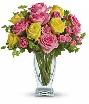Yellow and light pink roses, pink spray roses and fresh greenery. Approximately 13