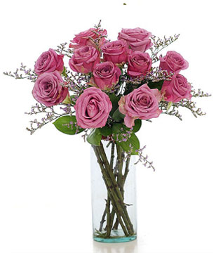 12 Purple roses in a glass vase 