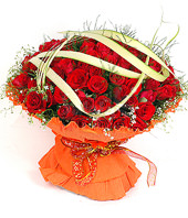 99 red roses with gladiolus and green foliages