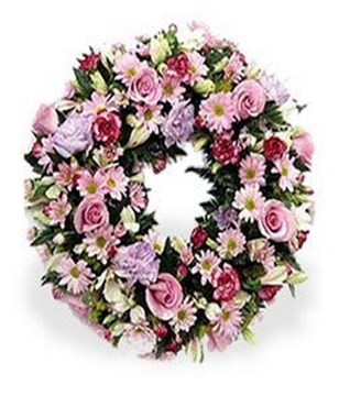 Gentle circular wreath of pastel pinks and creams.