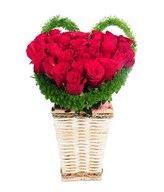 heart shape arrangement of red roses in square basket