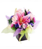 Pink lily, pink rose and fillers in vase