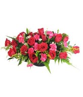 Red roses with seasonal blooms and greens